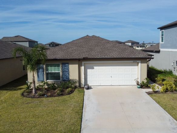 Front exterior of 12115 Smoky Emerald Ter, Parrish FL — sold single-family home with house number 12115 visible